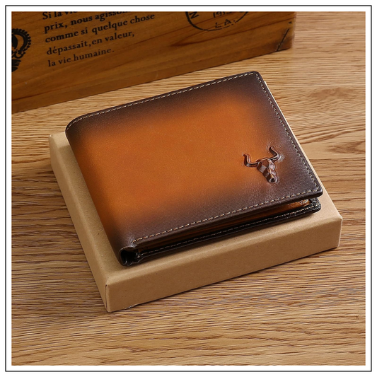 MING CLAN handcrafted Italian leather wallet placed on top of a minimal kraft gift box, featuring the signature embossed bull head logo.