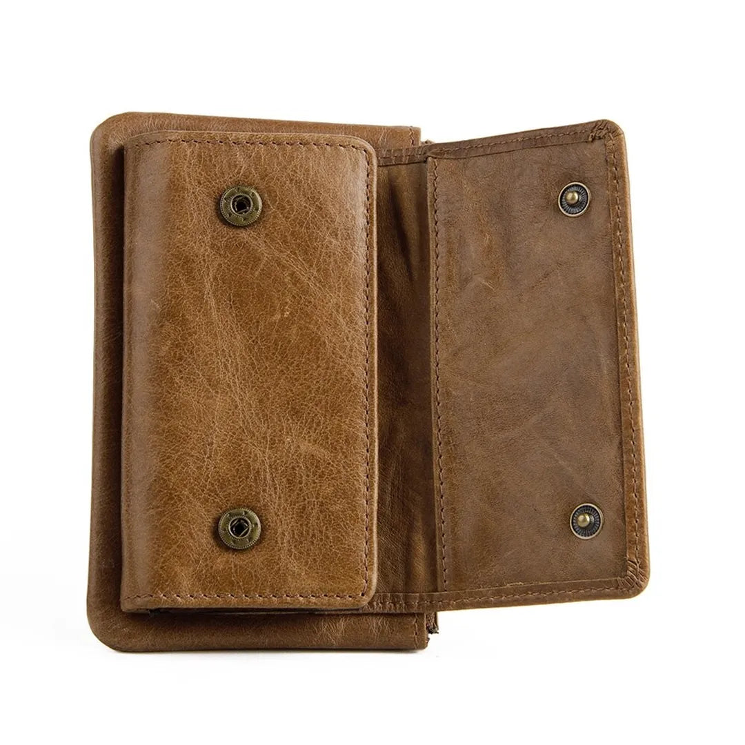 Close-up detail of the heavy-duty metal snap button and rich top-grain texture on the MING CLAN brown leather key wallet.